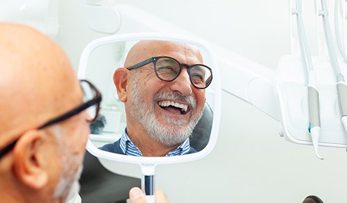 Man smiling with his new dental implants