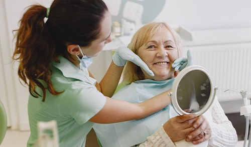 San Marcos patient smiling after getting implant dentures