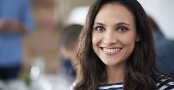 Smiling woman in black and white striped blouse