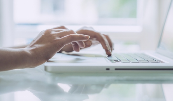 Person typing on laptop