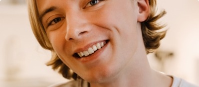 Close up of young man with blond hair smiling