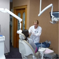 Dentist talking to a patient in the dental chair