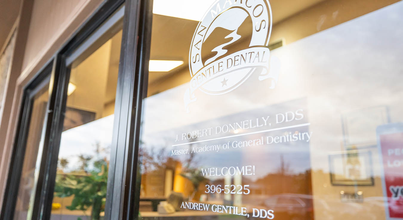 San Marcos Gentle Dental logo on outside of glass dental office door