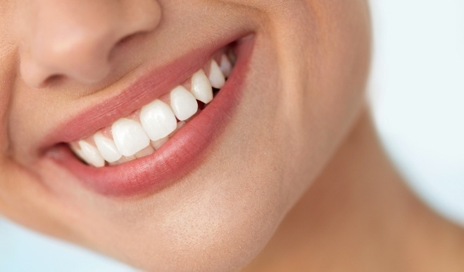 Close up of person smiling with straight white teeth