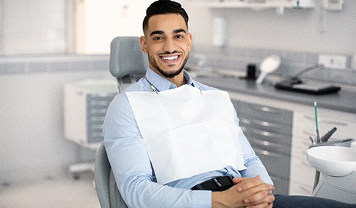 Patient smiling while sitting in treatment chair