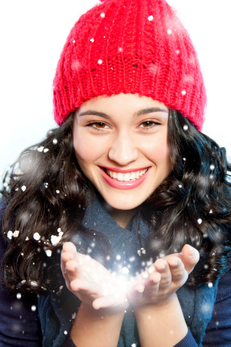 Christmas girl with snow in hands