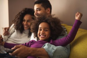 family smiling on the sofa