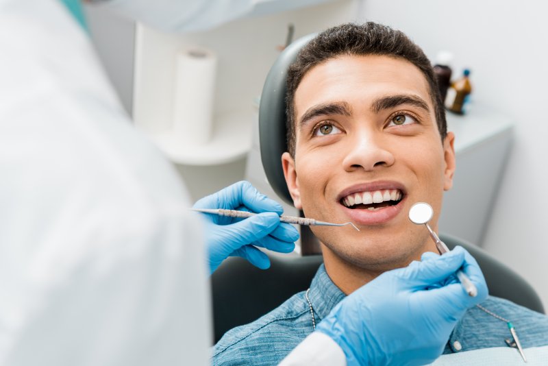 A dentist in San Marcos performing a dental checkup