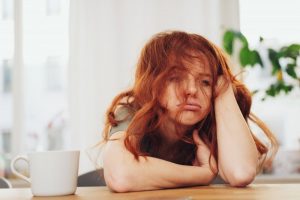 person sitting at table stressed out