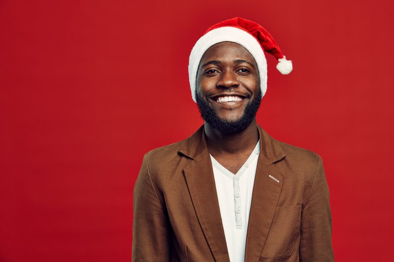 a man wearing a Santa hat and smiling