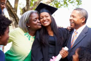 a family congratulating their child at their college graduation