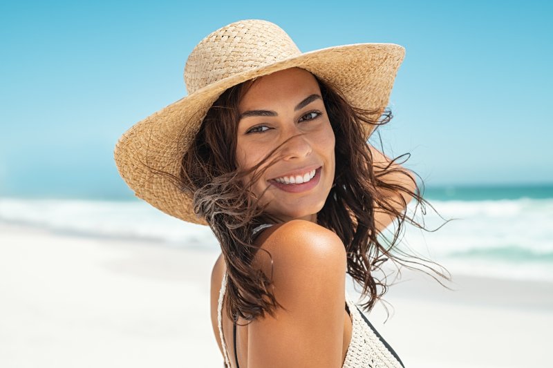 Woman smiling while enjoying vacation on the beach