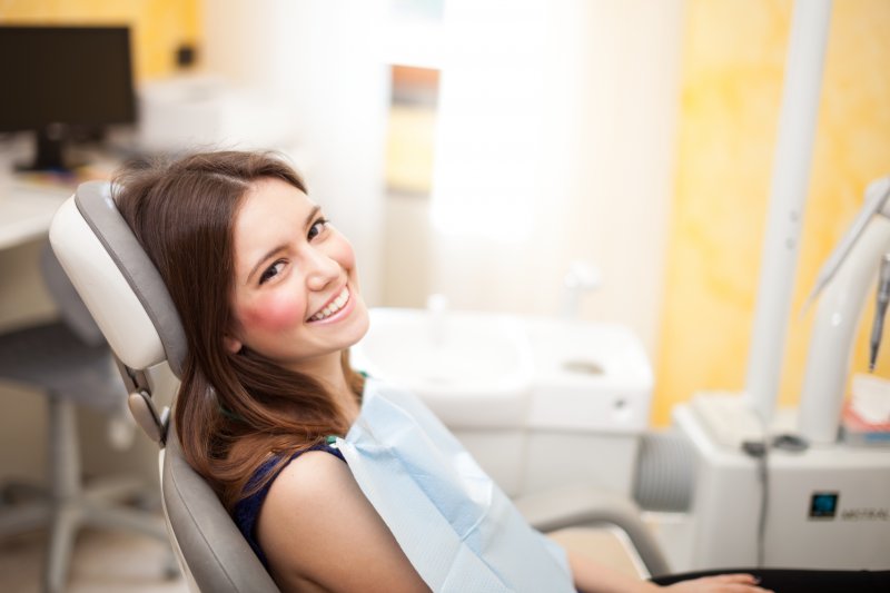 woman smiling sitting in dentist chair